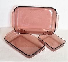 three pink dishes sitting on top of each other