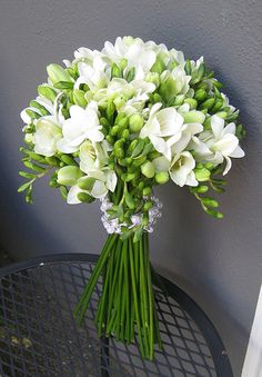 a bouquet of white flowers sitting on top of a table