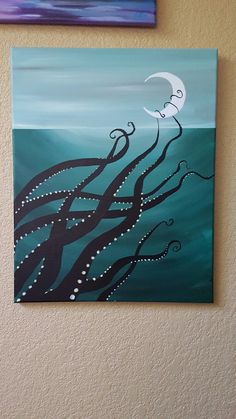 an octopus painting hanging on the wall next to a purple and blue background with a crescent moon above it