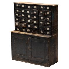 an old wooden cabinet with many drawers