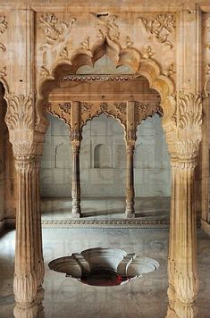 the inside of an old building with pillars and arches