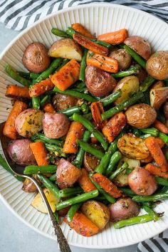 a white bowl filled with potatoes and green beans