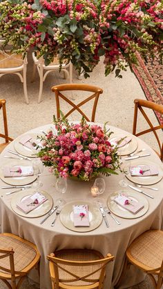 the table is set with flowers and place settings