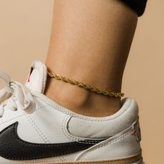 The Rope Chain features an intertwined pattern that offers a bold take on a timeless chain design, making this anklet perfect for those looking to make a subtle statement. This piece is available in two thicknesses. The model in the photo is wearing it at the thinner 2MM thickness. Materials & Warranty Anklet Length: 8 inch chain + 2 inch extension (10 inches total) | Extensions are available here. Material: Premium Stainless Steel, dipped in real 18 Karat Gold Hypoallergenic | Sensitive Skin-Fr Chain Design, Gold Piece, Donate To Charity, Chain Anklet, Drawstring Pouch, Silver Pieces, Ankle Bracelets, Gold Plated Silver, Rope Chain