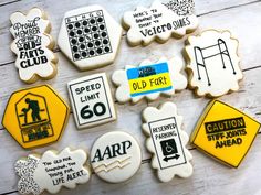 decorated cookies with different types of signs and words on them, all in white and yellow