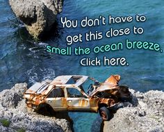 two rusted cars sitting on top of rocks next to the ocean with a quote