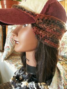 a mannequin head wearing a hat and scarf on top of a table next to a couch