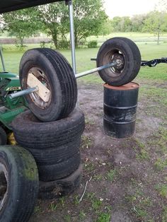 two large tires are stacked on top of each other in front of a tractor trailer