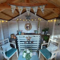 a living room with chairs and a table in it