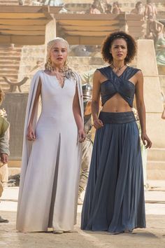 two women dressed in white and grey standing next to each other on the set of hbo's game of thrones