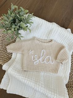 These adorable hand embroidered knit sweaters are custom made for your sweet little one! These personalized baby sweaters are a wonderful gift for baby showers for expecting mothers, holidays, special milestones, etc. They are also great for coming home outfits, name announcements, newborn/family photos, birthdays, and/or any other special events! STYLE/FIT: - Crew neck, Easy pull-over style - Loose fit through body - Hits below waist - Long sleeves - Rib-knit hem - Brand: Old Navy (Online Retai Baby Name Sweater, Hand Embroidered Name, Embroidery Yarn, Name Sweater, Newborn Family Photos, Pull Bebe, Sweater Fabric, Baby Birth Announcement, Embroidered Name