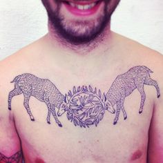 a man's chest with three deer tattoos on it