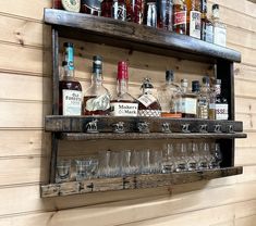 an old wooden shelf filled with bottles and glasses