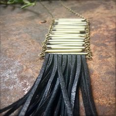 "-This necklace is comprised of 17 shed North American Porcupine Quills in a breastplate formation between antique-brass chains, with a beautiful black deerskin leather fringe hanging from it. -Necklace sits on the breastbone at 19.5\" in length. Quill breastplate and leather fringe hang down 11\" total. -Tips of the quills have been capped for safety. -Quills and leather are sustainably sourced in the USA. -Due to the natural materials used, quills may vary slightly in length and color from the Artisan Black Brass Necklaces, Black Brass Artisan Necklace, Artisan Black Brass Necklace, Artisan Black Soldered Necklace, Quill Jewelry, Porcupine Quills, South Pasadena, Native American Crafts, Deer Skin