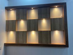 a wall mounted shelf with several lights on it