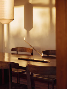 a wooden table with a lit candle on it