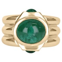 A one of a kind men's natural emerald cabochon ring. Featuring the center stone, with a full 3.42-carat cabochon with a beautiful dark green color. Accented by two smaller cabochons totaling 0.45tcw set north to south. All stones are carefully bezel set within its custom 14k yellow gold setting. The perfect everyday pinky ring. Setting Style: Bezel / Three-Stone Setting Material: 14K Yellow Gold Gold Weight: 12.2 Grams Main Stone: Emerald Cabochon Shape: Oval Cut Weight: 3.42-Carats Clarity: Tra Emerald Cabochon, Columbian Emeralds, Dark Green Color, Three Stone Ring, Cabochon Ring, Yellow Gold Setting, Stone Setting, Ring Setting, Emerald Jewelry