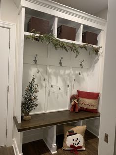 a bench with christmas decorations on it and some lights hanging from the wall behind it