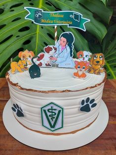 there is a cake decorated with dogs on the top and an image of a veterinaian