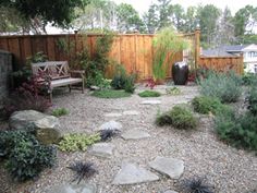 a garden with rocks and plants in it