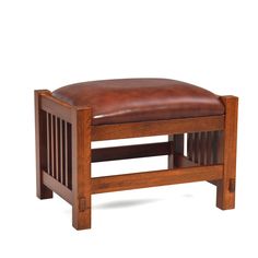 a wooden bench with leather seat cushion