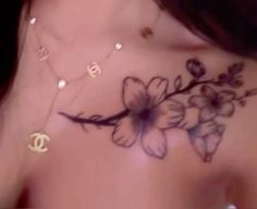 a close up of a woman's chest with flowers on it