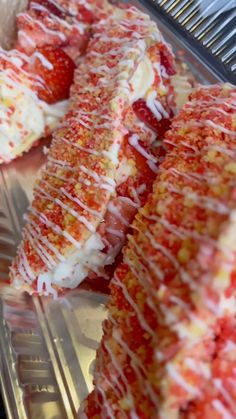 strawberry shortcakes with white icing and strawberries on the top are ready to be eaten