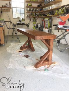 a workbench in a garage with tools on the floor