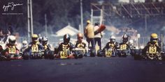 a group of people riding on top of motorcycles down a street next to each other