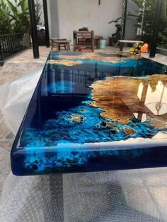 a glass table with blue and yellow paint on it