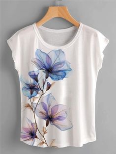 a white t - shirt with blue flowers painted on the front and back, hanging on a wooden hanger