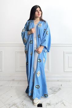 Featuring: Evil Eye & Hamsa Hand Embroidery Maxi Length Color: Blue.Fabric: LinenMultiple colors are available in the Evil Eye & Hamsa Hand abaya kimonoBrand: Unmatched BYU Length: 55 inches. Spring Blue Long Sleeve Abaya, Long Blue Cotton Kaftan, Blue Embroidered Long Abaya, Traditional Blue Kaftan With Chikankari Embroidery, Long Blue Kaftan With Dabka Work, Traditional Blue Cotton Kaftan, Embroidered Long Kimono For Eid, Blue Cotton Long Sleeve Kaftan, Long Sleeve Blue Abaya With Floral Embroidery