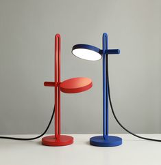 two different colored lamps sitting next to each other