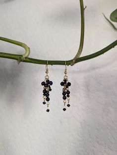 Make a statement with natural black tourmaline gemstones in this fairytale chain dangle earring design.  These bold yet feminine earrings give strong, confident vibes while offering the wearer protection against negative energies. The chains will move with every turn of your head, allowing the faceted stones to catch the light perfectly, elevating your look and your mood with every wear. The stainless steel earring wires ensure a hypoallergenic, comfortable, and wearable experience for even those with sensitive ears. Natural gemstones are believed to have special energetic and healing properties that are different for each stone and stone combination. If that hippie stuff is not for you... well, the colors are just stunning! Snag this one of a kind pair today. Elegant Black Chandelier Earrings With Dangling Beads, Elegant Black Long Drop Chandelier Earrings, Black Dainty Metal Jewelry, Dainty Black Metal Jewelry, Black Dainty Jewelry For Party, Black Chandelier Earrings With Black Beads As Gift, Black Bohemian Dangle Jewelry, Bohemian Black Dangle Jewelry, Elegant Black Beaded Chandelier Earrings