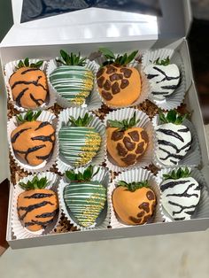 a box filled with chocolate covered strawberries on top of a table