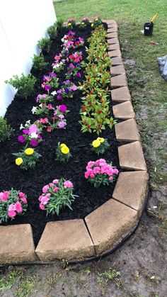 a flower bed with flowers planted in it