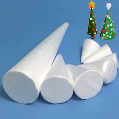 several pieces of white toilet paper on a blue surface with christmas trees in the background