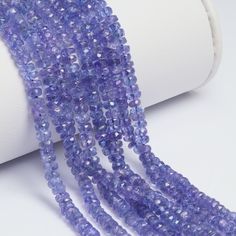 several strands of purple beads on a white surface