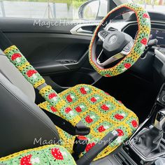 the interior of a car is decorated with crochet and has a steering wheel cover