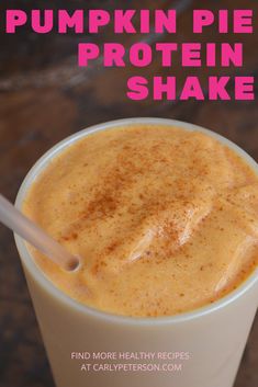 pumpkin pie protein shake in a white cup with a straw sticking out of the top