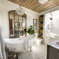 a bathroom with a tub, toilet and sink in it's center piece is shown