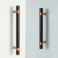 two black and copper handles on the wall