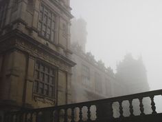 an old building is shown in the fog