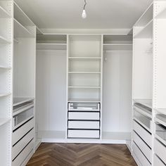 an empty walk in closet with shelves and drawers