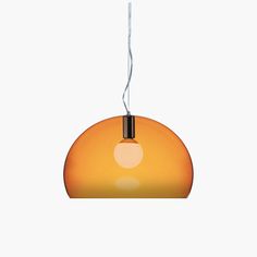 an orange light hanging from a ceiling fixture