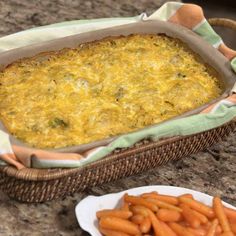 a casserole dish and plate of carrots on a table