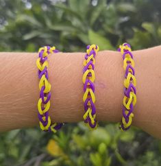 Set of 2 or 3 matching friendship bracelets purple and gold rubber band loom bracelets.  This item is specially handmade and designed by my 11 year old son. Other color options may be available upon request.  Measures about 7 inches around but is stretchy. Hypoallergenic Purple Friendship Bracelets, Loom Bracelets, Rubber Bands, Braided Bracelets, Loom, Color Options, Friendship Bracelets, Violet, Jewelry Bracelets