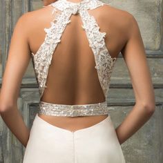 the back of a woman's wedding dress, with an open - back design