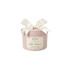 a pink candle with a white bow on it's top and the words dolce written