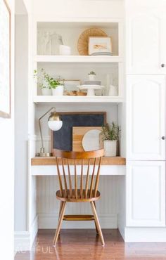 a wooden chair sitting in front of a white book shelf